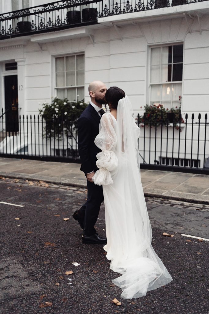 Bride and Groom kissing on the streets after getting married at Chelsea Town Hall