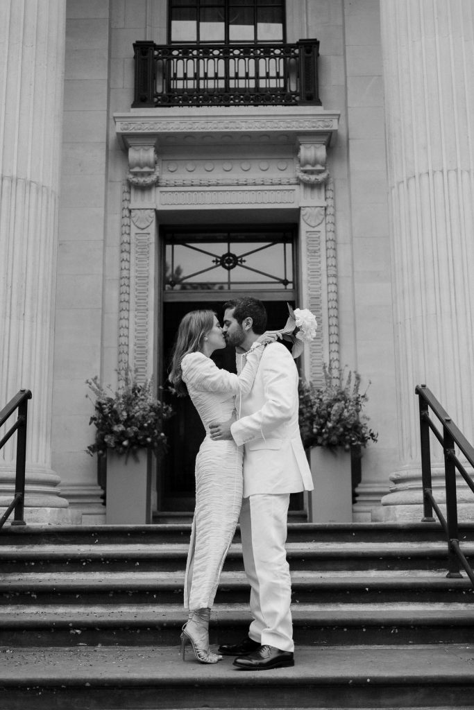 Bride and Groom kissing on the steps of the Old Marylebone Town Hall